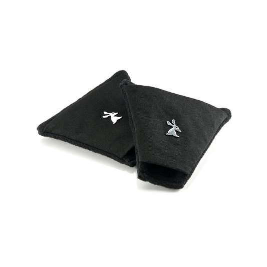 A pair of black ear warmers with a soft fleece lining and a YAKKAY animal pin attached to one side.