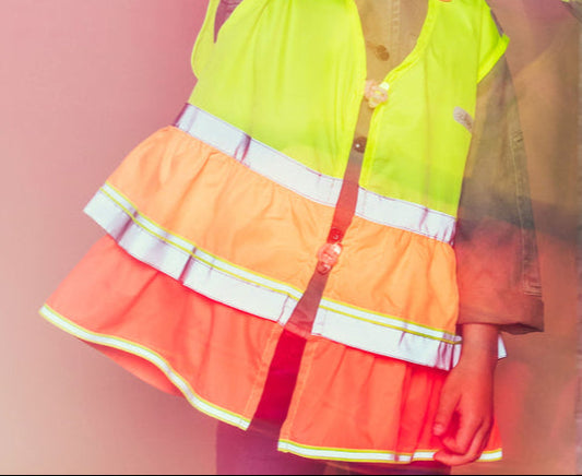 safety vest yellow and orange ruffles, on a pink background.