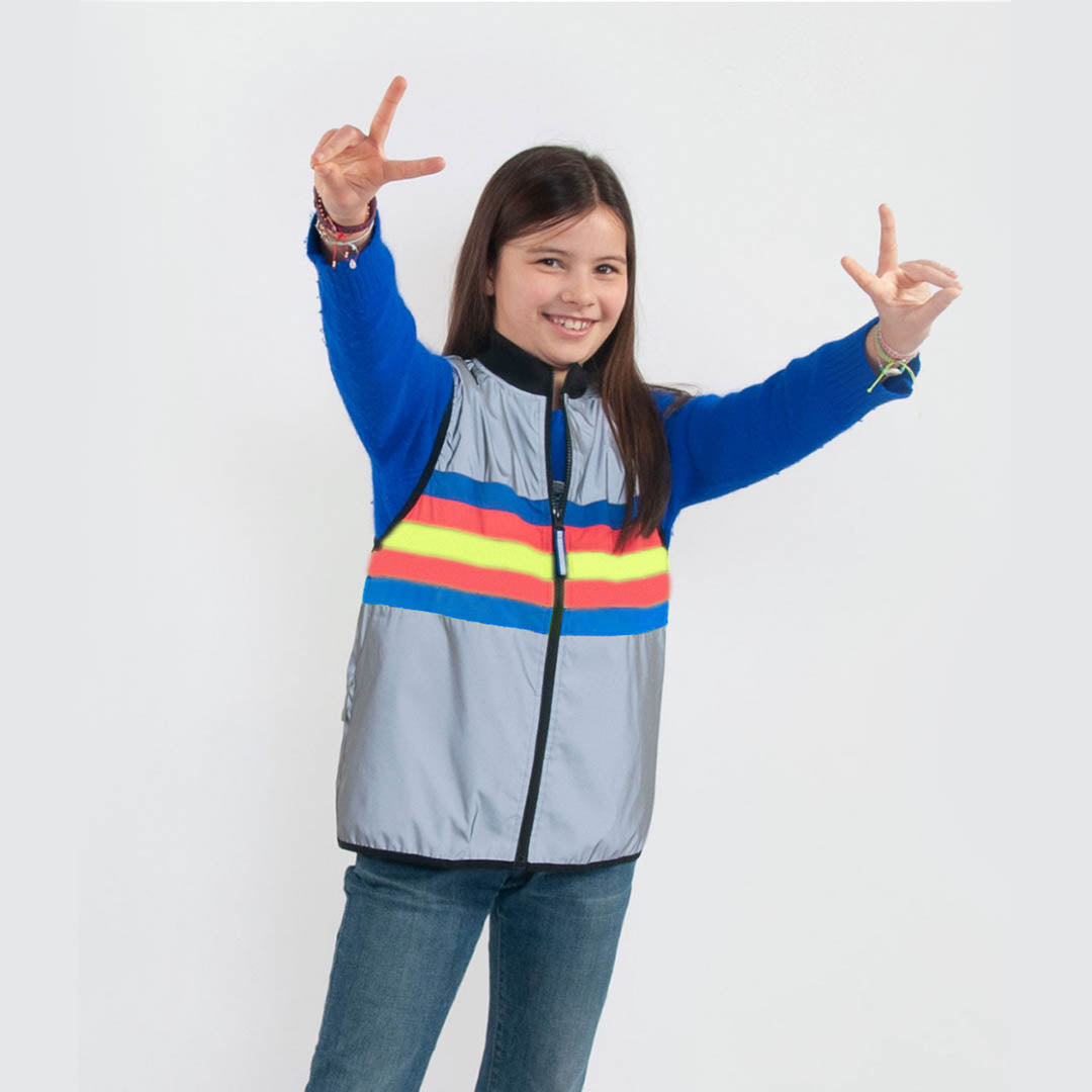 Child wearing a colorful jacket with a white background