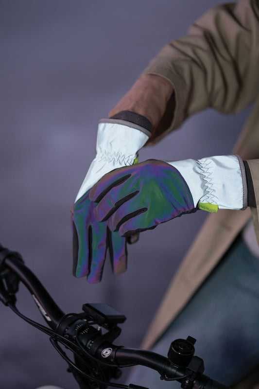Close-up of a gloved hand on a bicycle handlebar with a blurred background