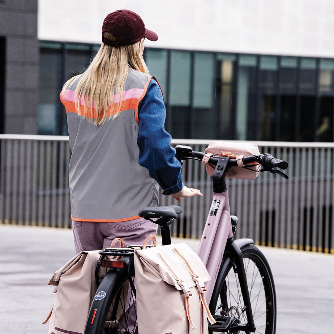 Person with a bicycle in an urban setting