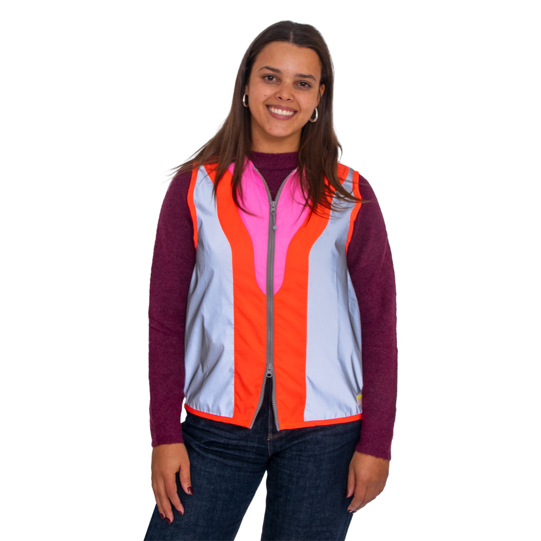 Woman wearing a colorful vest with a white background