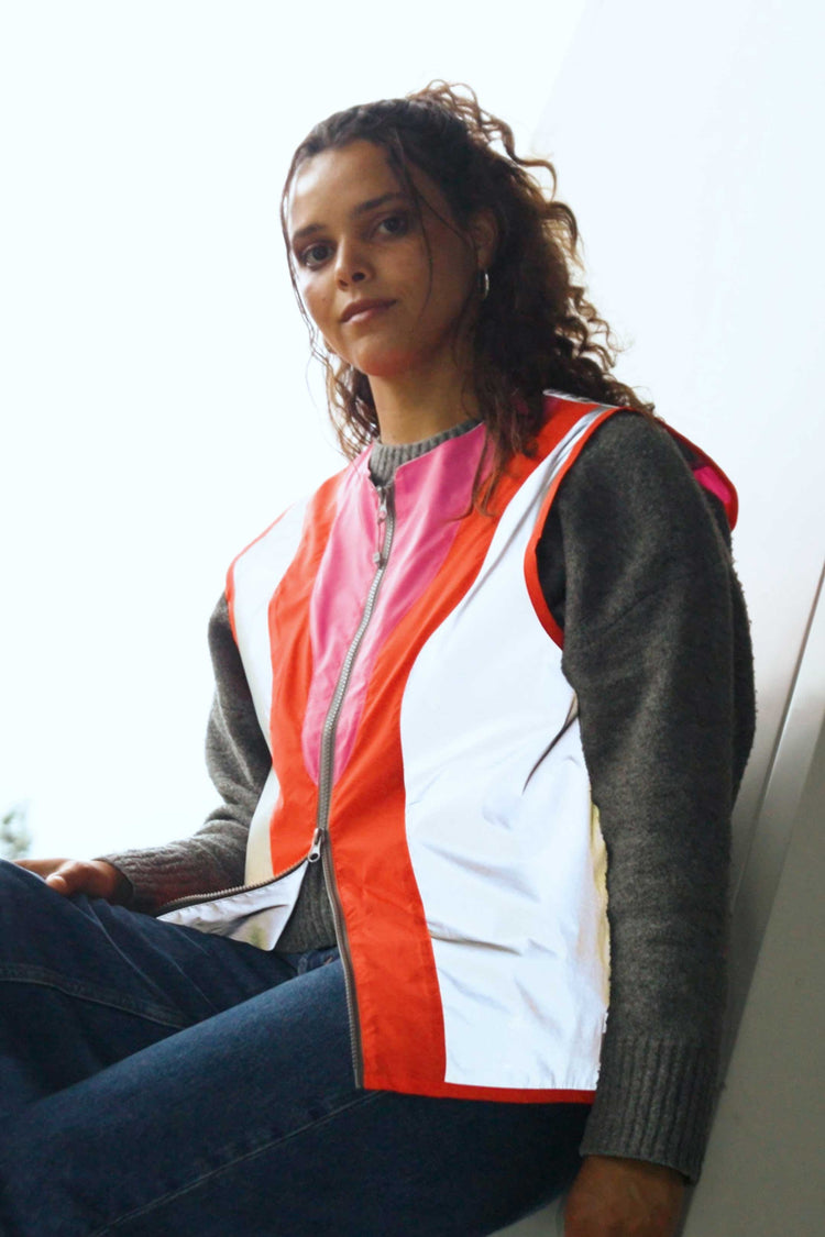 Person wearing a colorful vest with a white background