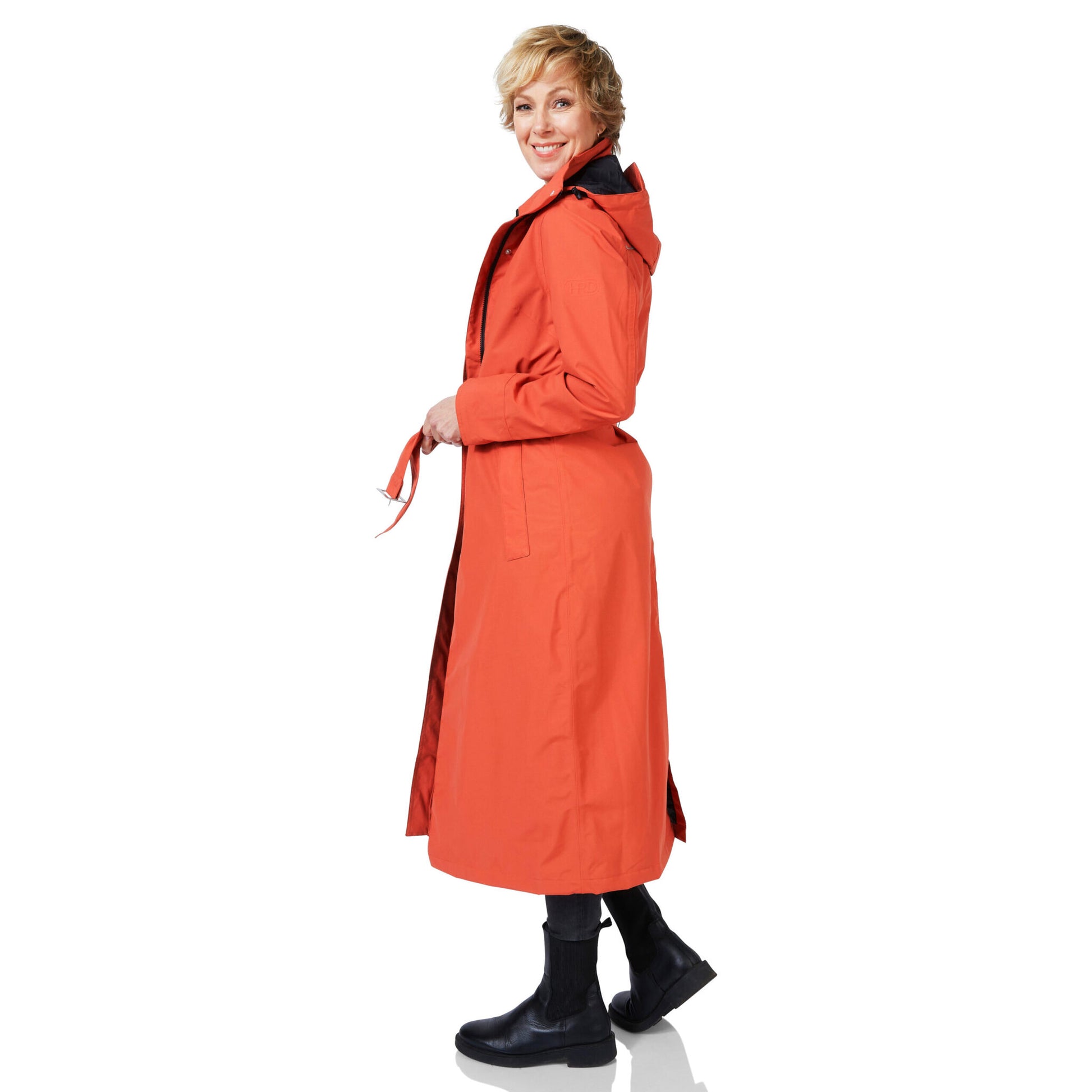 Woman wearing an orange trench coat on a white background