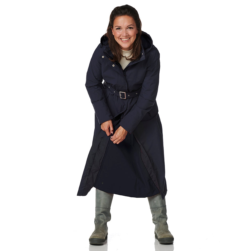 Woman wearing a navy blue trench coat on a white background