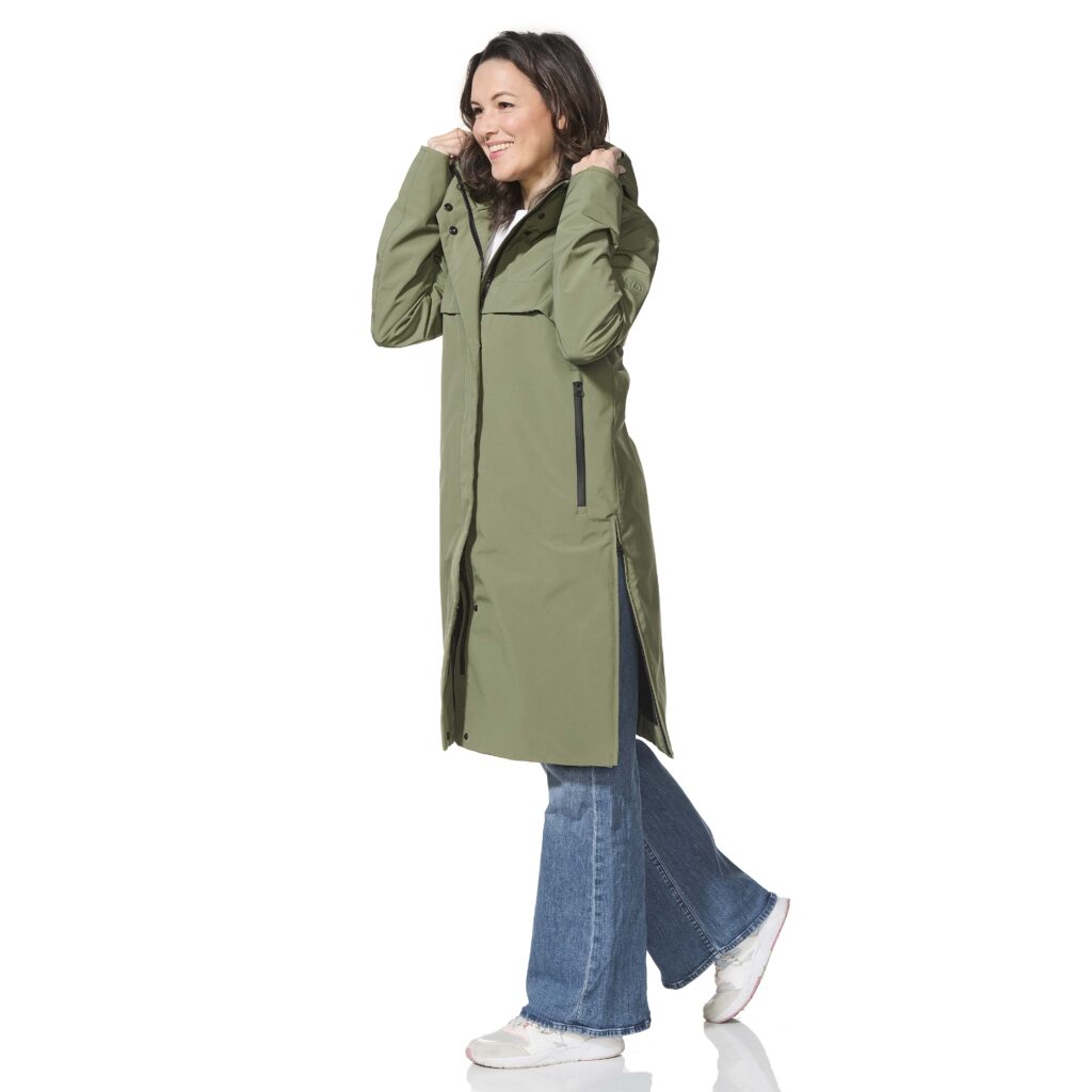 Woman wearing a green coat on a white background