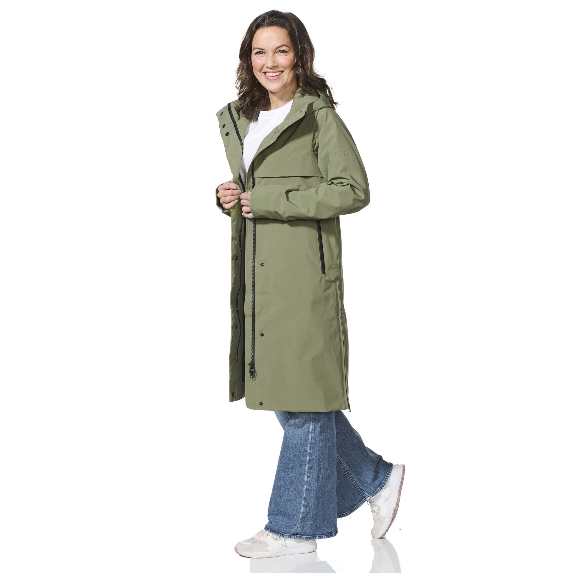Woman wearing a green raincoat on a white background